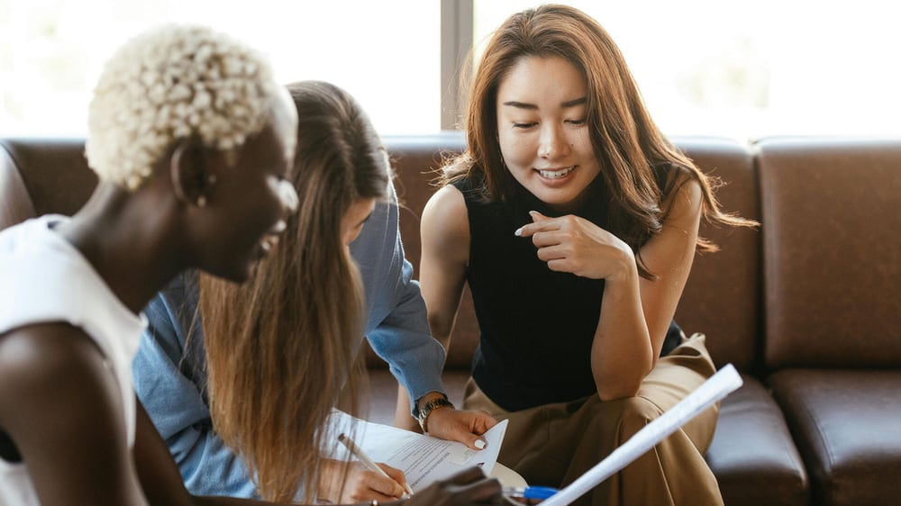 Drei Frauen testen die kostenlosen Funktionen von Semrush am Computer aus.